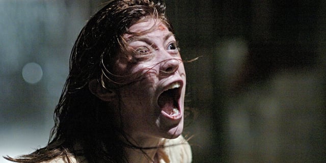 Jennifer Carpenter as Emily Rose, screaming as her hair flies around her face in The Exorcism of Emily Rose