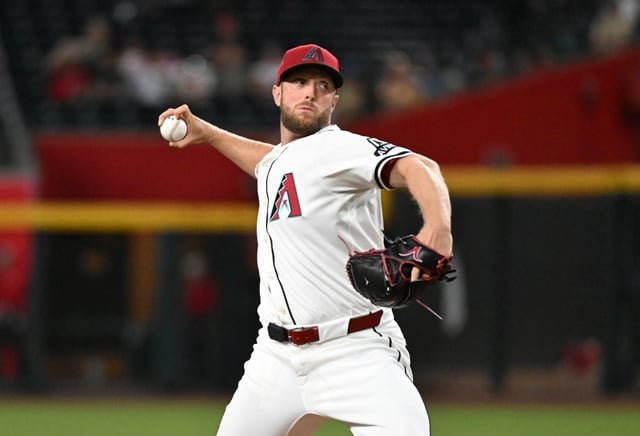 PHOENIX, ARIZONA - JULY 20: Merrill Kelly #29 of the Arizona Diamondbacks delivers a first inning pitch against the St. Louis Cardinals at Chase Field on July 20, 2025 in Phoenix, Arizona.