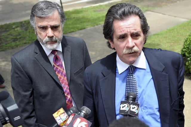 FILE - Attorney Thomas Durkin, right, answers questions from reporters with Hinds County Circuit Judge Bobby DeLaughter, left, as they make their way into the federal courthouse in Aberdeen, Miss., July 30, 2009, (AP Photo/Ryan Moore, File)