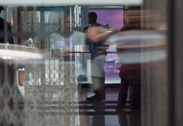 A person with a knife can be seen inside the lobby of the Dirksen U.S. Courthouse on July 22, 2025. The building was placed on lockdown. (Terrence Antonio James/Chicago Tribune)