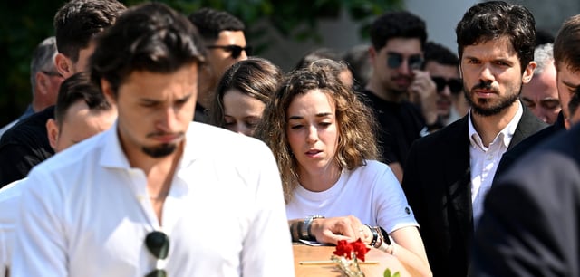 Rute Cardoso (M.) bei der Beerdigung am Sarg ihres verstorbenen Ehemanns