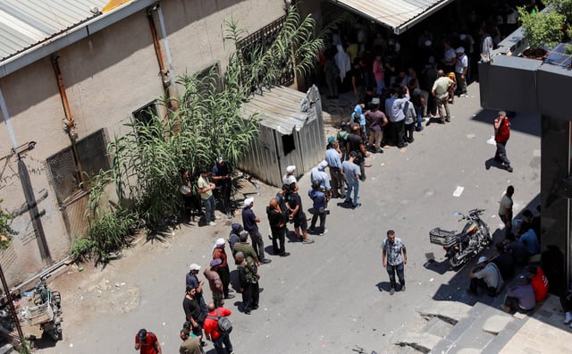 People queue to get bread in Sweida, Syria, as hundreds of Bedouin civilians were evacuated from Syria's predominantly Druze city of Sweida on Monday as part of a U.S.-backed truce meant to end days of bloodshed in southern Syria, state media and witnesses said, July 22, 2025. REUTERS/Fahed Kewan