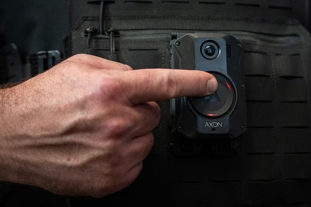 A Delta police officer demonstrates recording on a body camera during a news conference by the B.C. Association of Chiefs of Police about implementing body-worn cameras for officers, in Surrey, B.C. on Thurs. Jan. 11, 2024. The City of Vancouver has announced it is launching a pilot program for its parking officers due to a rise in verbal and physical threats and assaults.