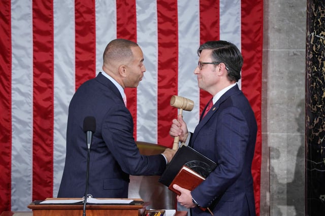House Minority Leader Hakeem Jeffries hands newly-elected House Speaker Mike Johnson the gavel at the Capitol on Oct. 25, 2023.