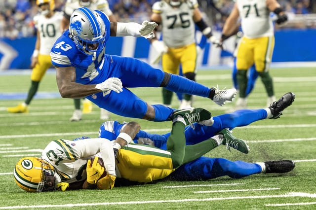 Dec 5, 2024; Detroit, Michigan, USA; Detroit Lions defensive back Jamal Adams (25) tackles Green Bay Packers wide receiver Dontayvion Wicks (13) with help from linebacker David Long Jr. (43) during the fourth quarter at Ford Field. Mandatory Credit: David Reginek-Imagn Images/File Photo