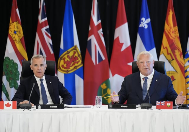 Ontario Premier Doug Ford, right, speaks as Canadian Prime Minister Mark Carney listens as they address the premiers of Canada during the 2025 summer meetings of Canada's Premiers at Deerhurst Resort in Huntsville, Ont., on Tuesday, July 22, 2025.  