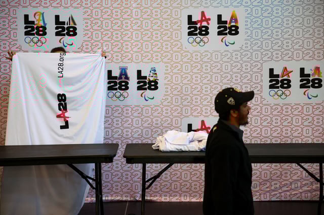Workers pack up a space used for a press conference held by the International Olympic Committee Coordination Commission for the Los Angeles 2028 Olympic and Paralympic Games at UCLA, Los Angeles, California, U.S., November 14, 2024. REUTERS/Daniel Cole/File Photo