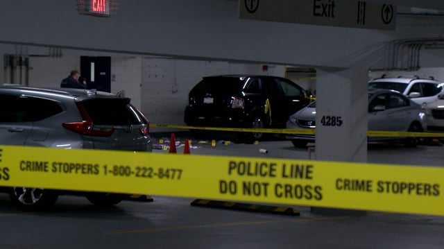 Calgary homicide investigators examine the scene of a fatal shooting on Saturday, inside a parkade in the Calgary community of Haysboro.  A 23-year-old woman from Okotoks was killed.