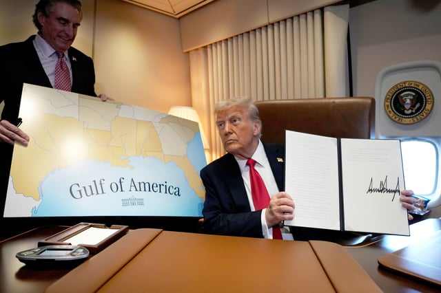 FILE - President Donald Trump holds up a signed proclamation declaring Feb. 9 Gulf of America Day, as Interior Secretary Doug Burgum watches aboard Air Force One as Trump travels from West Palm Beach, Fla. to New Orleans, Feb. 9, 2025. (AP Photo/Ben Curtis, File)