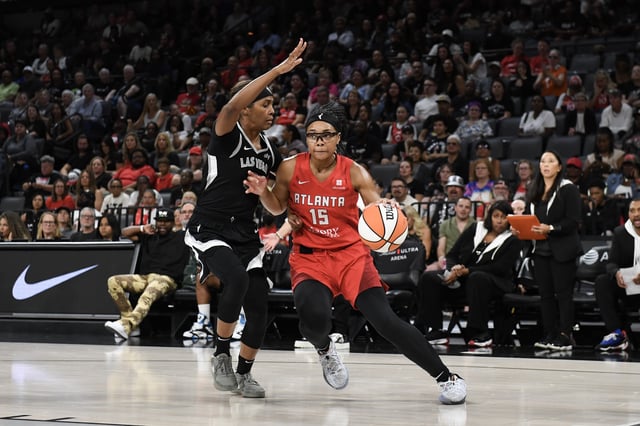 Allisha Gray #15 of the Atlanta Dream drives against Sydney Colson #51 of the Las Vegas Aces during the second quarter of their game at Michelob ULTRA Arena on August 30, 2024 in Las Vegas, Nevada.