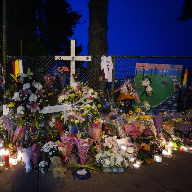 People hold a candlelight vigil in Vancouver, on Friday, May 2, 2025, on the street where a vehicle-ramming attack occurred at the Filipino community's Lapu Lapu Day festival on April 26. THE CANADIAN PRESS/Darryl Dyck