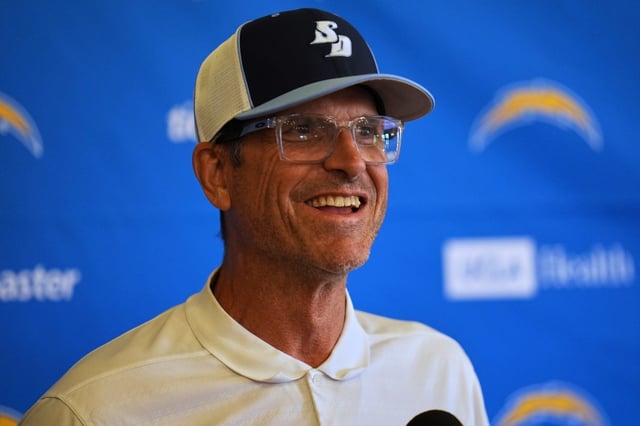 Chargers head coach Jim Harbaugh speaks to reporters during a training camp practice on Tuesday, July 22, 2025, in San Diego. The Chargers are practicing at USD for two days, which is where Harbaugh got his first head coaching job. (AP Photo/Gregory Bull)