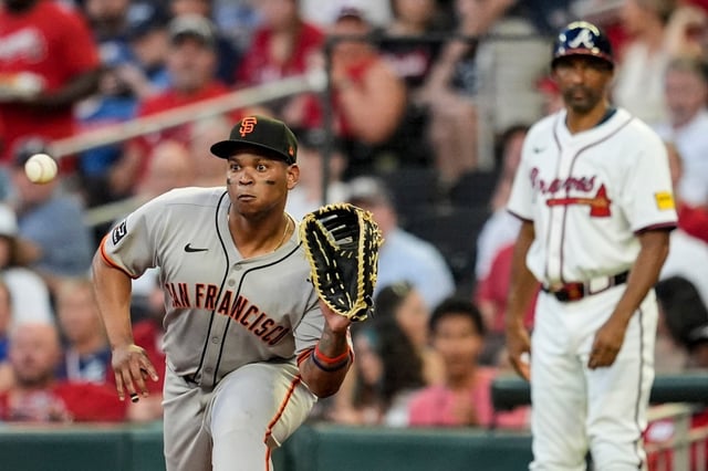 San Francisco Giants’ Rafael Devers (16) makes the tag on Atlanta Braves’ Nick Allen (2) at first base in the fifth inning of a baseball game, Tuesday, July 22, 2025, in Atlanta. (AP Photo/Mike Stewart)