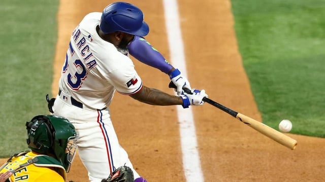 Jul 22, 2025; Arlington, Texas, USA; Texas Rangers right fielder Adolis Garcia (53) hits a home run during the fourth inning against the Athletics at Globe Life Field. Mandatory Credit: Kevin Jairaj-Imagn Images