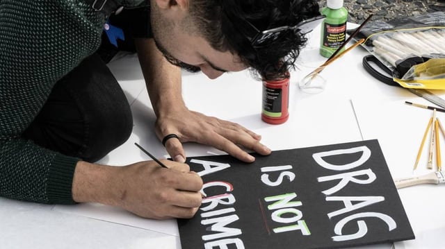 A protester makes a sign during a protest in San Francisco. Drag performances have because a flash point in culture wars, particularly in Florida where a local official is under investigation for possibly exposing children to a sexualized performance. File Photo by Terry Schmitt/UPI