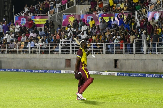 Andre Russell waves to fans at his home ground in Kingston, Jamaica, after batting for the final time in international cricket against Australia on Tuesday