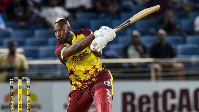 Andre Russell of West Indies hits a four during his last international match