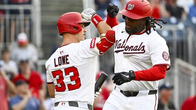 Jul 22, 2025; Washington, District of Columbia, USA; Washington Nationals designated hitter Josh Bell (19) is congratulated by first baseman Nathaniel Lowe (33) after hitting a solo home run against the Cincinnati Reds during the fourth inning at Nationals Park. Mandatory Credit: Brad Mills-Imagn Images