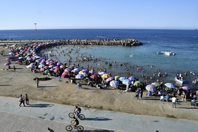 People enjoy the beach in Algiers, Friday, July 18, 2025. (AP Photo/Fateh Guidoum)