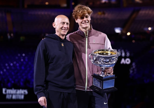 Tennis - Australian Open - Melbourne Park, Melbourne, Australia - January 28, 2024 Italy's Jannik Sinner poses for a picture with the trophy and fitness coach Umberto Ferrara after winning the final against Russia's Daniil Medvedev REUTERS/Issei Kato/File Photo
