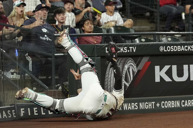 Arizona Diamondbacks catcher Jose Herrera dives in vain for a foul ball hit by Houston Astros&#39; Brice Matthews during the fourth inning of a baseball game Tuesday, July 22, 2025, in Phoenix. (AP Photo/Ross D. Franklin)