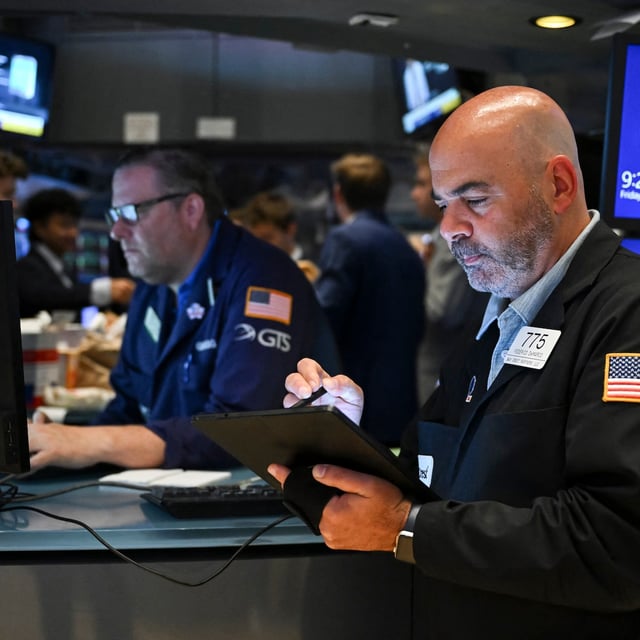 Traders work on the floor of the New York Stock Exchange (NYSE) at the opening bell on July 18, 2025, in New York City. Upbeat company earnings and healthy US data buoyed stock markets on Friday, pushing ongoing concerns about President Donald Trump's tariffs into the background. New York -- whose S&P 500 and Nasdaq Composite struck record highs on July 17 -- held on to gains, even if the Dow struggled a little at the start. Most European and Asian markets were pulled higher as well. (Photo by ANGELA WEISS / AFP) (Photo by ANGELA WEISS/AFP via Getty Images)