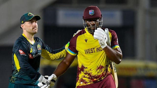 Josh Inglis (L) of Australia and Andre Russell (R) of West Indies shake hands