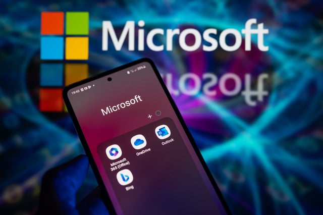 Microsoft apps are being displayed on a smartphone, with the Microsoft logo visible in the background, in this photo illustration taken in Brussels, Belgium, on December 30, 2023. (Photo by Jonathan Raa/NurPhoto)