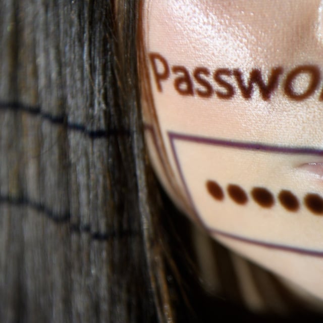 a password log-in box is projected onto a woman's face