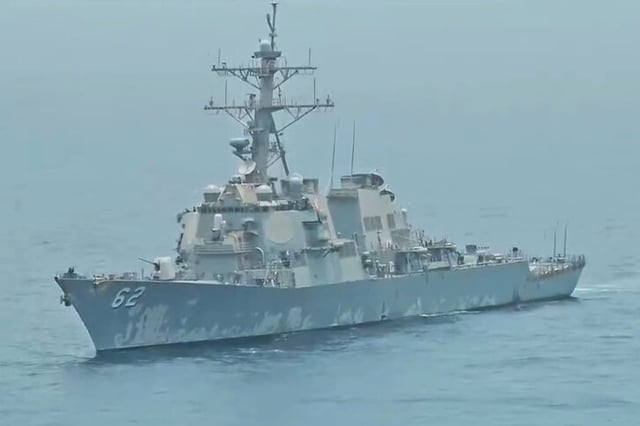 A still image from a video shared by Iranian state media that it said captured the moment an Iranian naval helicopter confronted the USS Fitzgerald, a U.S. naval destroyer, in the Gulf of Oman, on Thursday, July 23, 2025.