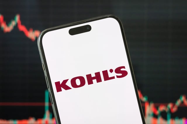 In this photo illustration, the logo of Kohl&#39;s Corporation is displayed on a smartphone screen, with a stock market chart of the company in the background.