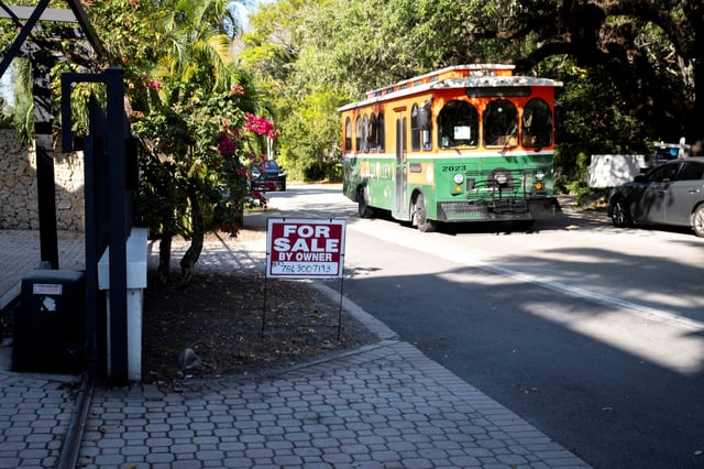 A "For Sale" sign stands at a house in Miami, Florida, U.S. April 16, 2025. REUTERS/Marco Bello/File Photo