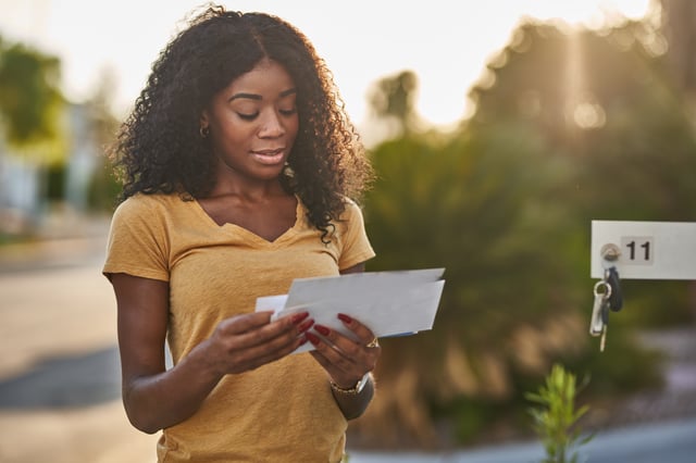 Stock image/file photo: A woman checking her mail.