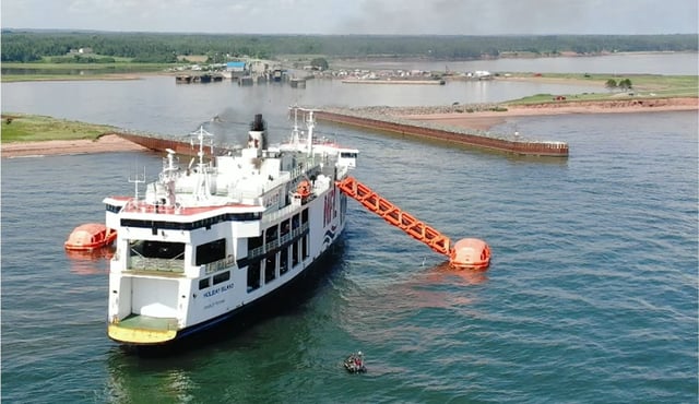 The ferry MV Holiday Island is seen in this handout photo, at the entrance to the Wood Islands terminal, with the marine evacuation slides and life rafts deployed, on July 22, 2022. THE CANADIAN PRESS/Handout - TSB, North River Fire Department (Mandatory Credit)