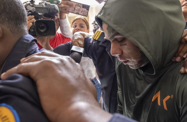 FILE - Rapper Daniel Hernandez, known as Tekashi 6ix9ine, is escorted by police at the Palace of Justice, in Santo Domingo, Dominican Republic, Jan. 20, 2024. (AP Photo/Ricardo Hernández, file)