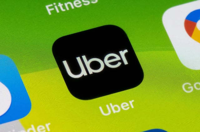 In this photo illustration, a close-up of an Uber app is seen on an iPhone on Feb. 19, 2021, in Cardiff, Wales.(Matthew Horwood/Getty Images/TNS)