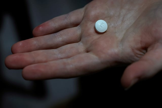 A patient prepares to take Mifepristone, the first pill in a medical abortion, at Alamo Women's Clinic in Carbondale, Illinois, U.S., April 9, 2024. REUTERS/Evelyn Hockstein/File Photo