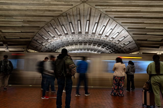 Commuters wait to board a red line train at the Metro Center metro station in Washington, DC, US, on Thursday, April 17, 2025.