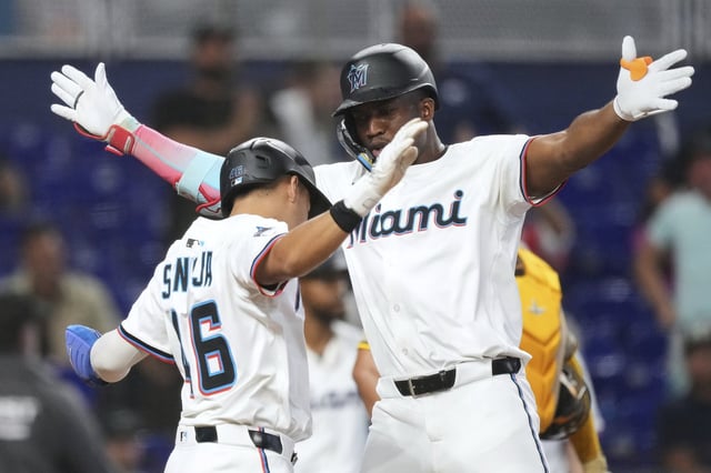 Miami Marlins' Jesus Sanchez, right, celebrates after hitting a home run that also brought home Javier Sanoja, left, in the fifth inning of a baseball game against the San Diego Padres, Wednesday, July 23, 2025, in Miami. (AP Photo/Rebecca Blackwell)