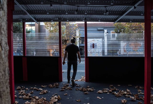 A man walks through an empty outdoor sitting area in front of Curio in San Francisco&#39;s Mission District where restrictions were to take effect during a COVID-19 surge on Dec. 6, 2020. A new study found accelerated brain aging among those who lived through the COVID-19 pandemic.