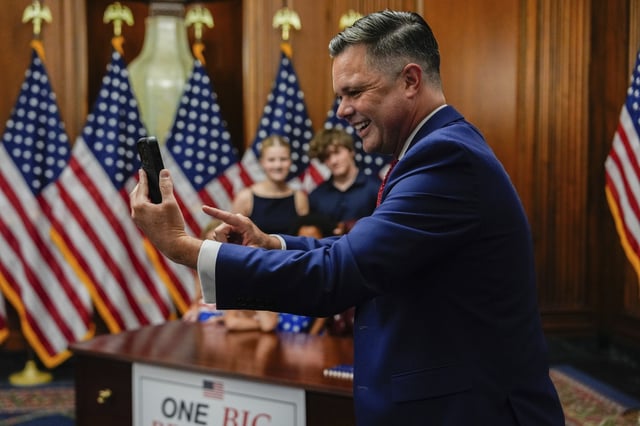 Rep. Zach Nunn, R-Iowa, takes a selfie following the passage of President Donald Trump's signature bill of tax breaks and spending cuts, Thursday, July 3, 2025, at the Capitol in Washington. (AP Photo/Julia Demaree Nikhinson)