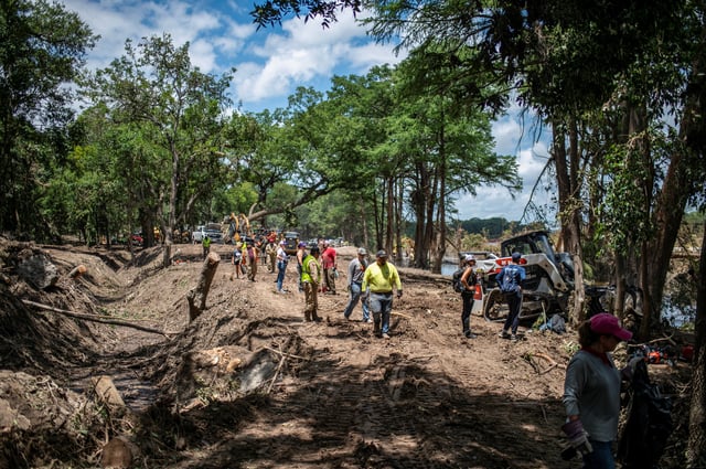 Volunteers work to clear the area around the Guadalupe River near Camp Camp after catastrophic floods in Center Point, Texas, U.S., July 11, 2025.   REUTERS/Sergio Flores/File Photo