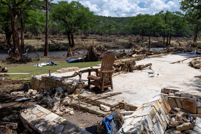 A chair stands amid the ruins of a house near the Guadalupe River, in Hunt, Texas, U.S., July 9, 2025. REUTERS/Umit Bektas/File Photo