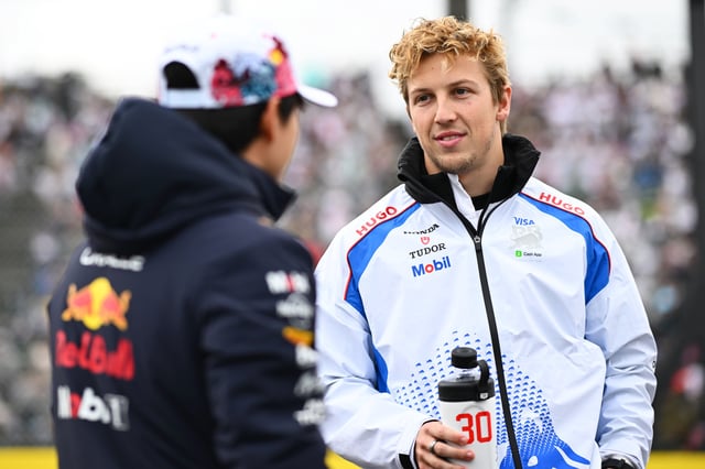 Yuki Tsunoda of Japan and Oracle Red Bull Racing and Liam Lawson of New Zealand and Visa Cash App Racing Bulls talk on the drivers parade prior to the F1 Grand Prix of Japan at Suzuka Circuit on April 06, 2025 in Suzuka, Japan.