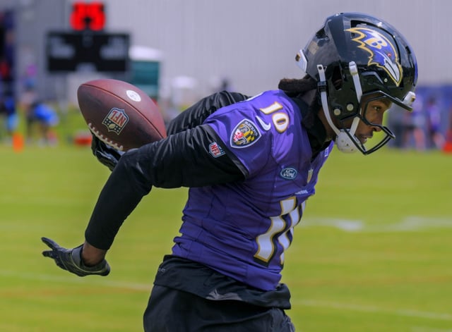 Saving a wide pass from quarterback Lamar Jackson with a flick of his fingertips, Baltimore Ravens wide receiver DeAndre Hopkins makes an incredible catch that he flipped over his shoulder and behind the back during the first day on training camp. (Karl Merton Ferron/Staff)