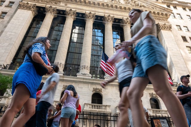 People walk outside of the New York Stock Exchange on July 23, 2025.