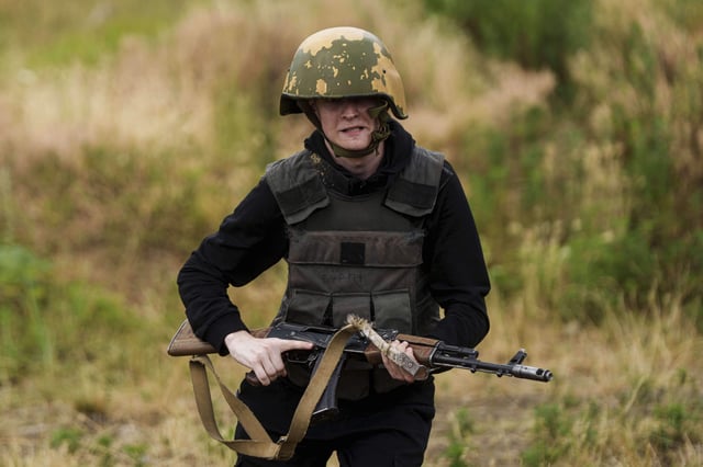 A Ukrainian 3rd Assault Brigade recruit runs to take a position during a training at the polygon in Kyiv region, Ukraine, on Wednesday, July 16, 2025. (AP Photo/Evgeniy Maloletka)