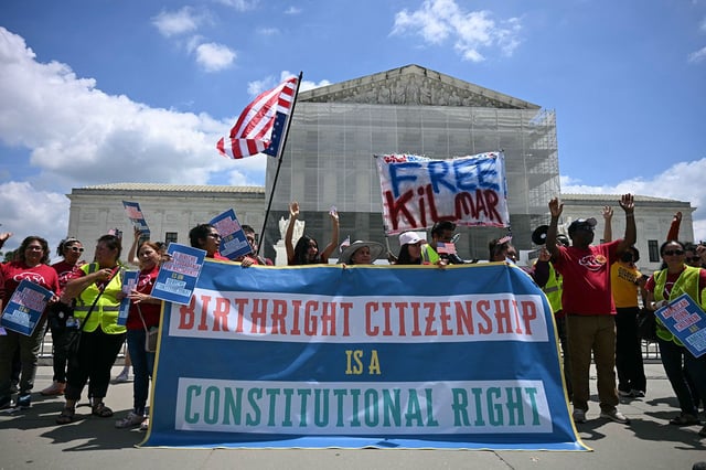 People hold a banner as they participate in a protest outside the US Supreme Court over President Donald Trump's move to end birthright citizenship as the court hears arguments over the order in Washington, DC, on May 15, 2025.
