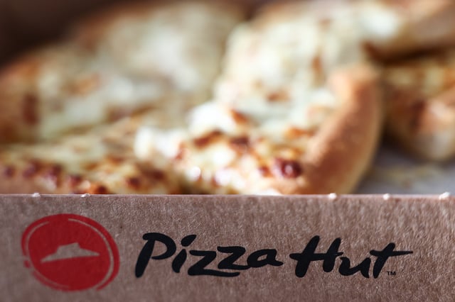Pizza Hut logo is seen on a pizza box in this illustration photo taken in Krakow, Poland on March 16, 2025. 