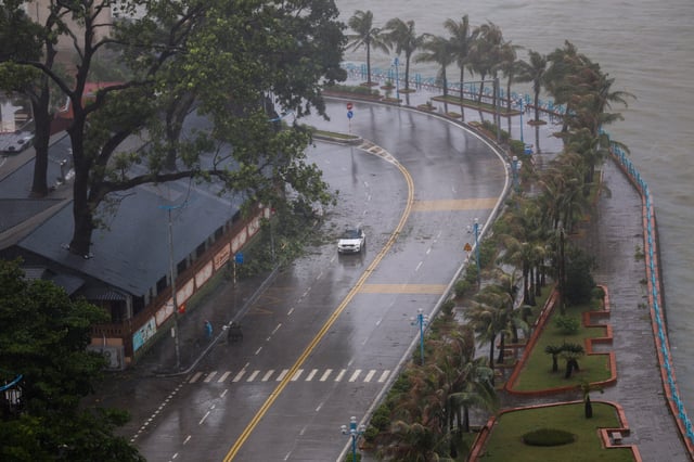 A car moves on a road as Tropical Storm Wipha approaches, in Quang Ninh province, Vietnam, July 22, 2025. REUTERS/Thinh Nguyen/File Photo